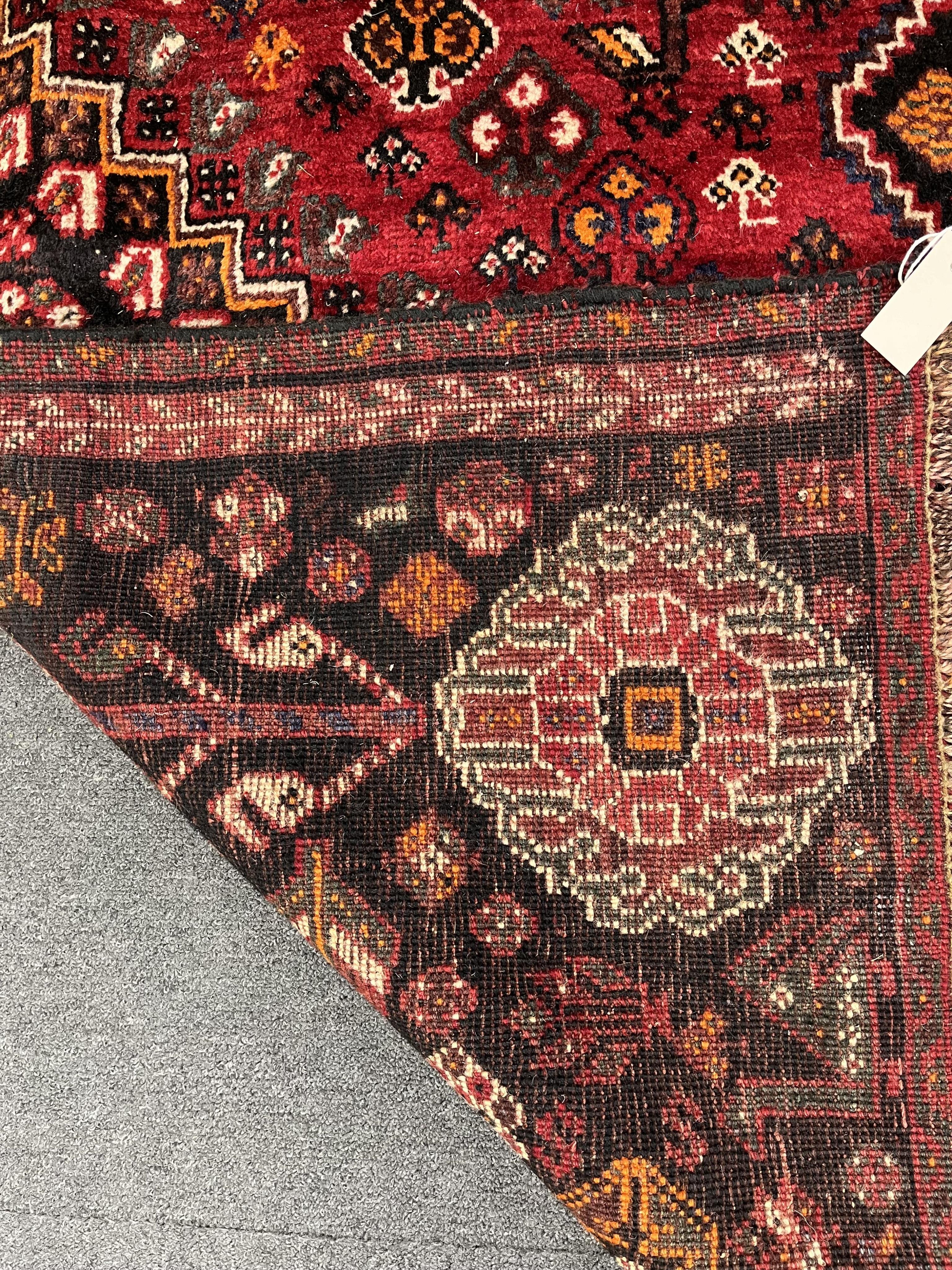 A Caucasian red ground rug, 280 x 185cm. Condition - good